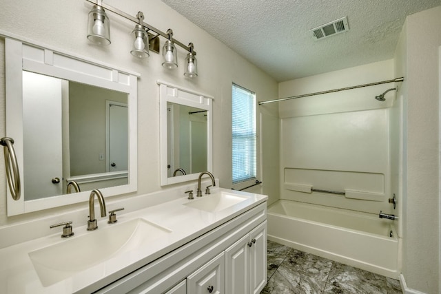 full bath featuring a textured ceiling, tub / shower combination, visible vents, and a sink