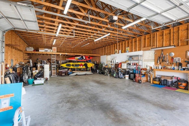 garage with a workshop area and a garage door opener