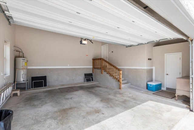 garage featuring a garage door opener and electric water heater