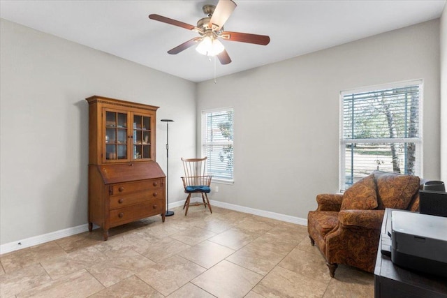 sitting room featuring baseboards and ceiling fan