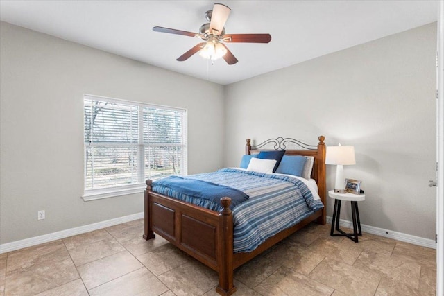 bedroom featuring baseboards and a ceiling fan