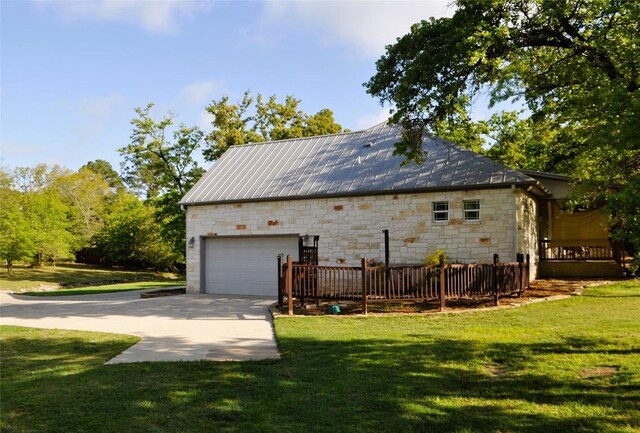 151 William Higgins Dr, Bastrop, TX 78602 - view of property exterior with stone siding, a lawn, and a garage