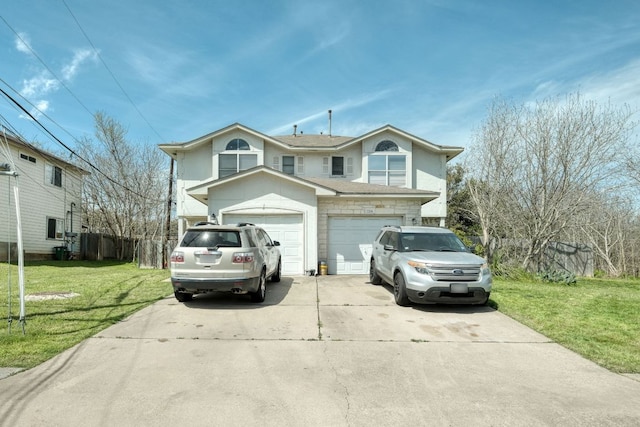 traditional home featuring driveway, an attached garage, a front yard, and a shingled roof