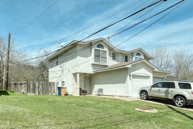 view of home's exterior featuring a lawn, an attached garage, and fence