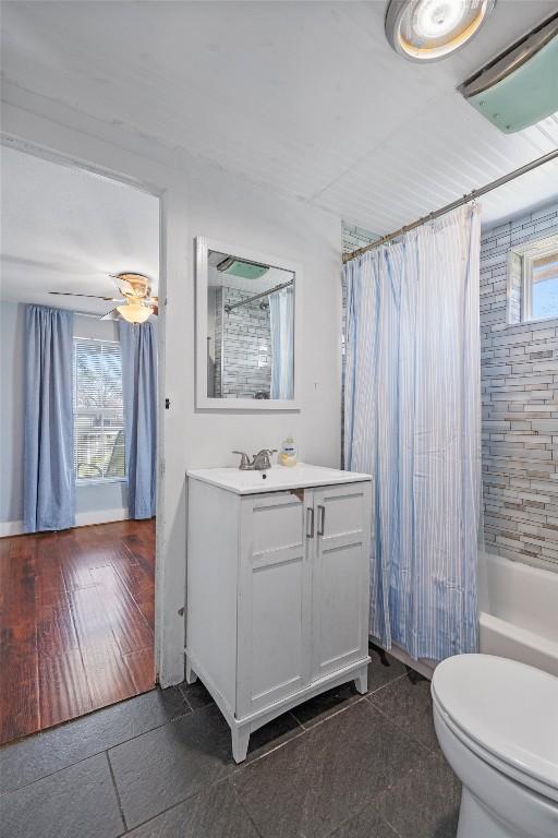 full bath featuring vanity, toilet, and shower / bathtub combination with curtain