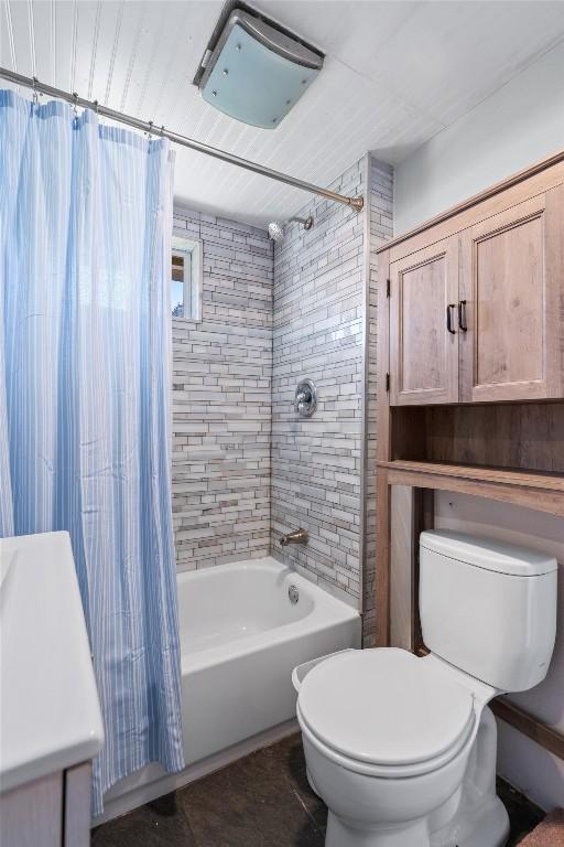 full bath featuring shower / bath combo with shower curtain and toilet