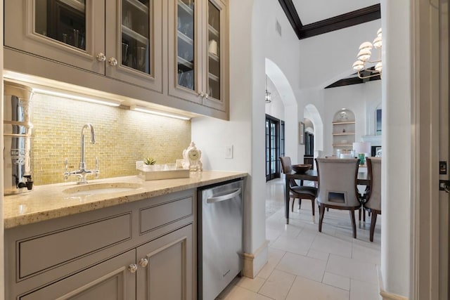 kitchen with visible vents, ornamental molding, a sink, arched walkways, and dishwasher