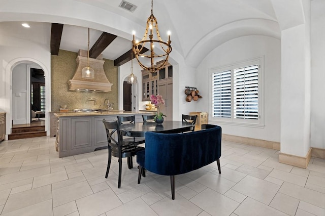 dining room with visible vents, vaulted ceiling with beams, baseboards, a chandelier, and arched walkways