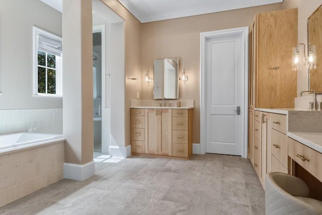 full bath featuring a garden tub, two vanities, a sink, crown molding, and baseboards