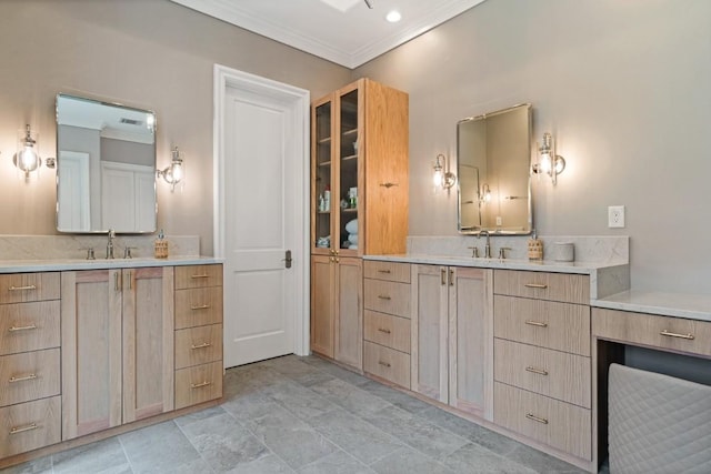 full bath with a sink, two vanities, and ornamental molding