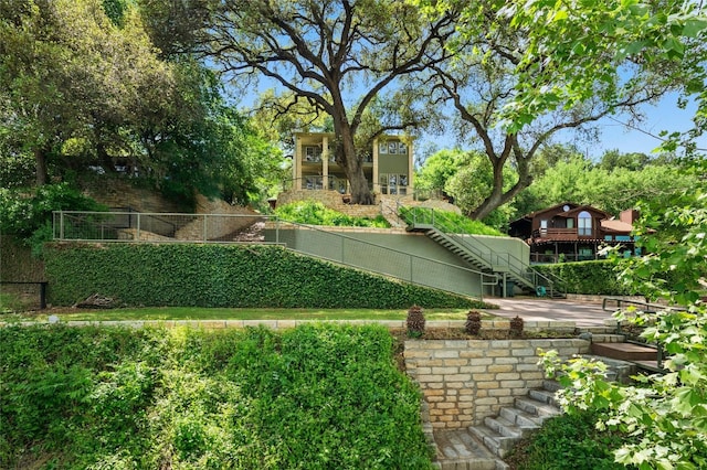 view of yard with stairway and fence