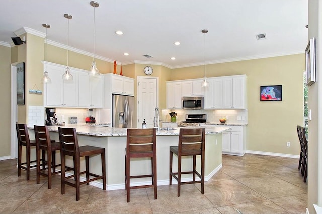 kitchen with visible vents, a breakfast bar area, a peninsula, stainless steel appliances, and white cabinetry