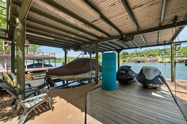 dock area with a water view and boat lift