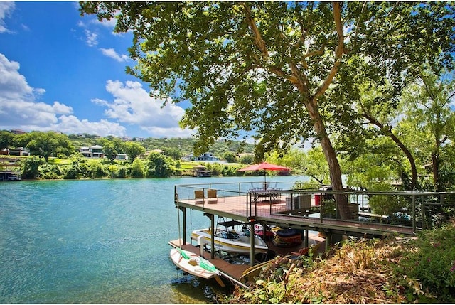 dock area with a water view and boat lift