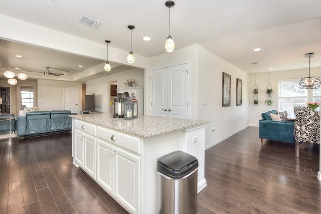 kitchen featuring visible vents, baseboards, dark wood finished floors, open floor plan, and ceiling fan with notable chandelier