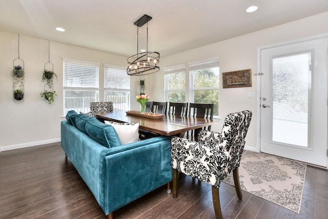 dining room featuring plenty of natural light, an inviting chandelier, and dark wood-style floors