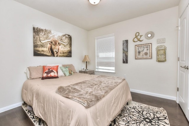 bedroom featuring baseboards and wood finished floors