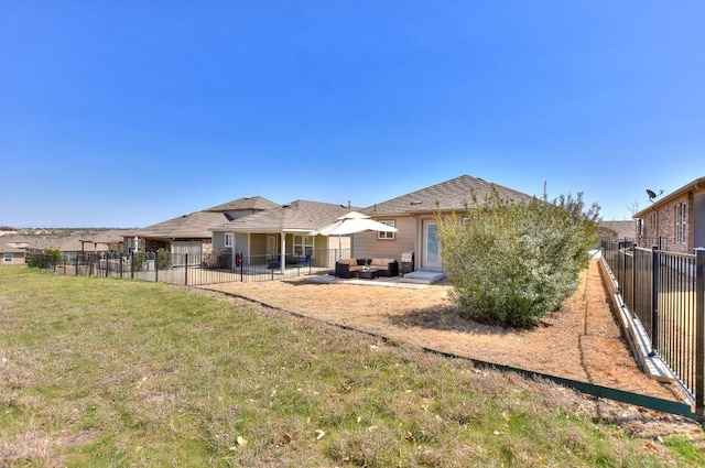 back of property with a lawn, a patio, and fence