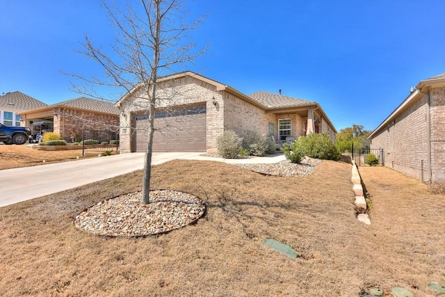 ranch-style home featuring brick siding, driveway, an attached garage, and fence