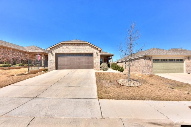 ranch-style home with brick siding, an attached garage, and driveway