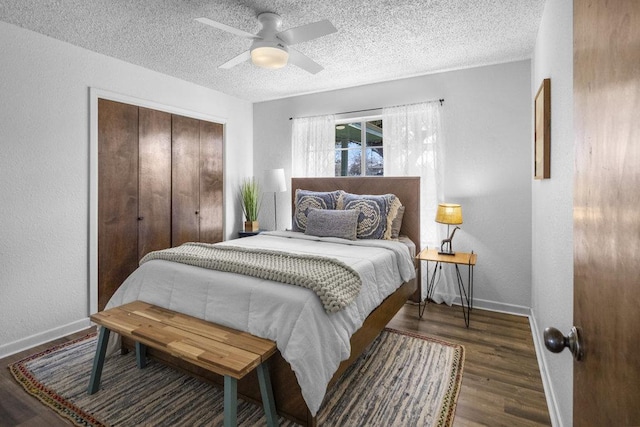 bedroom featuring wood finished floors, baseboards, a closet, and a textured ceiling