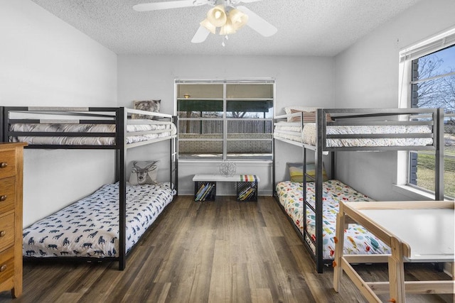 bedroom featuring a textured ceiling, wood finished floors, and a ceiling fan