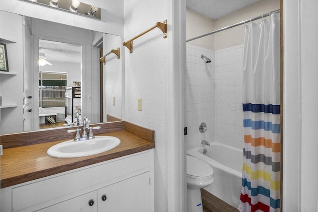 bathroom featuring shower / bathtub combination with curtain, toilet, a textured ceiling, vanity, and a textured wall