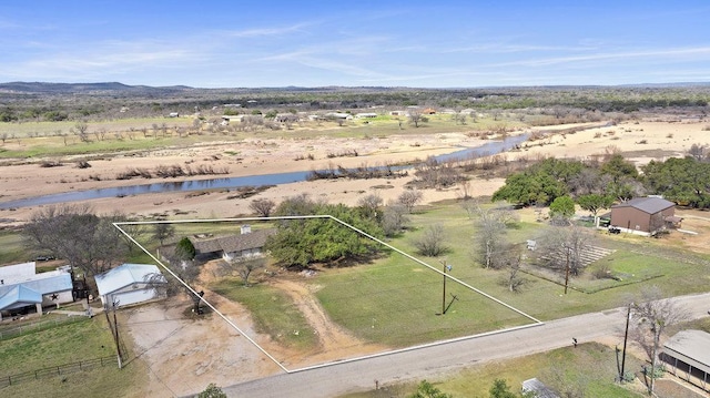 birds eye view of property with a water view and a rural view