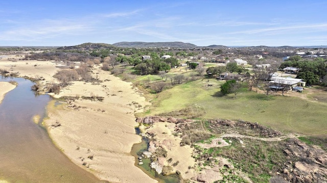 birds eye view of property with a water and mountain view