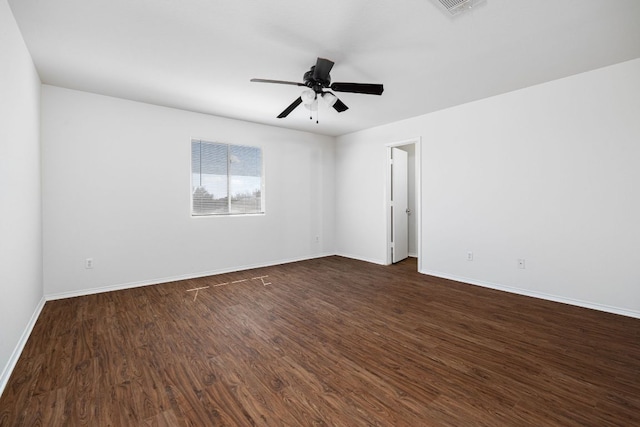 empty room with dark wood finished floors, baseboards, and ceiling fan