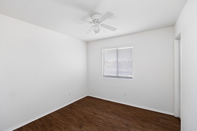 unfurnished room with baseboards, ceiling fan, and dark wood-style flooring