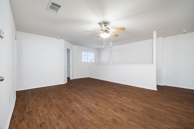 spare room with visible vents, baseboards, dark wood-style floors, and ceiling fan