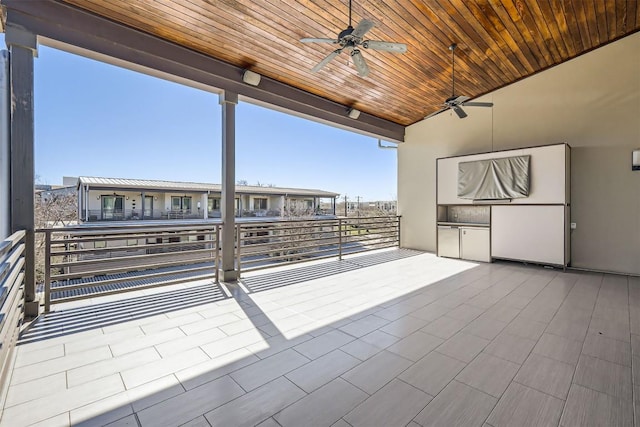 view of patio / terrace featuring a balcony, an outdoor kitchen, and a ceiling fan