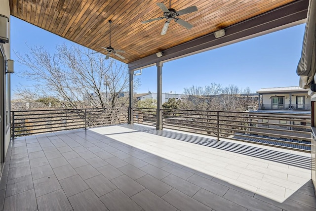 view of patio with a ceiling fan and a balcony