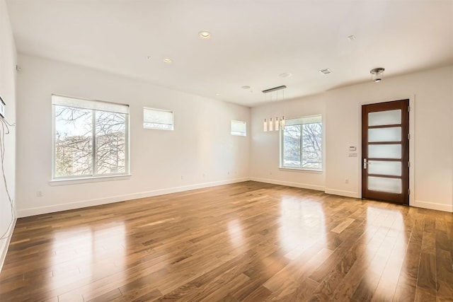 unfurnished room featuring recessed lighting, baseboards, and wood finished floors