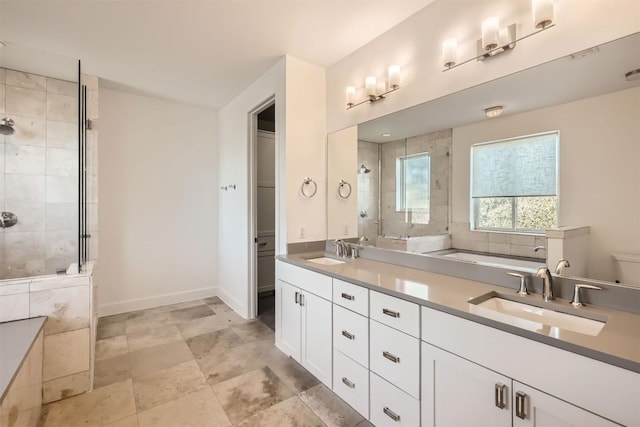 bathroom featuring a sink, baseboards, tiled shower, and double vanity