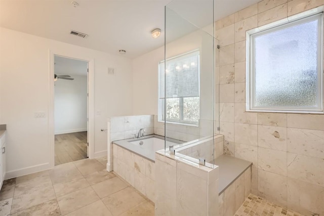 bathroom featuring baseboards, visible vents, tiled shower, tile patterned floors, and a bath