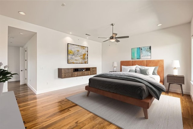 bedroom with recessed lighting, wood finished floors, and visible vents