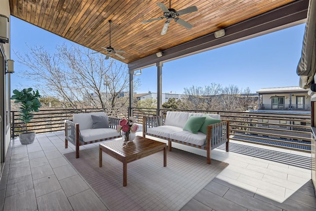 view of patio with a balcony, an outdoor living space, and ceiling fan