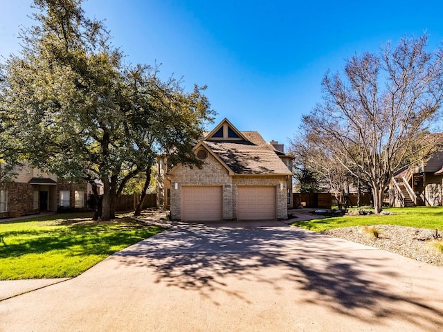 view of front of property with a front lawn, fence, concrete driveway, a garage, and brick siding