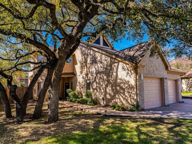 view of front facade with brick siding, concrete driveway, and an attached garage