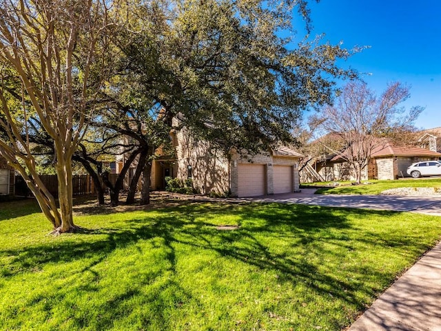 view of front facade with a front yard, driveway, and fence