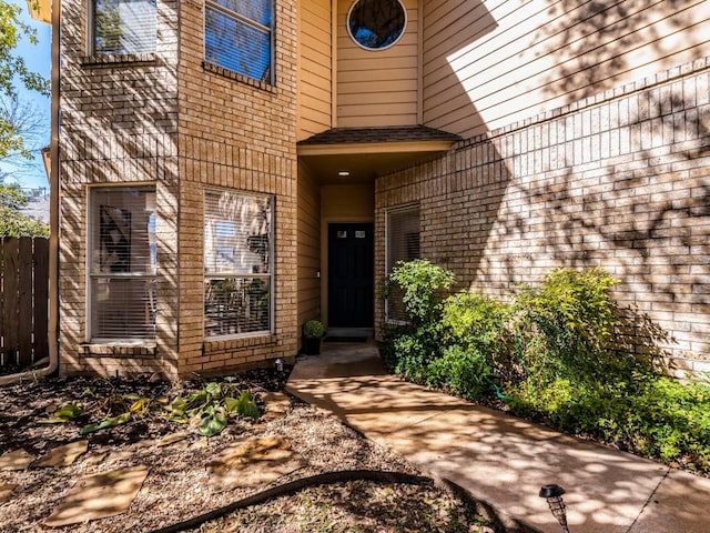 doorway to property featuring fence