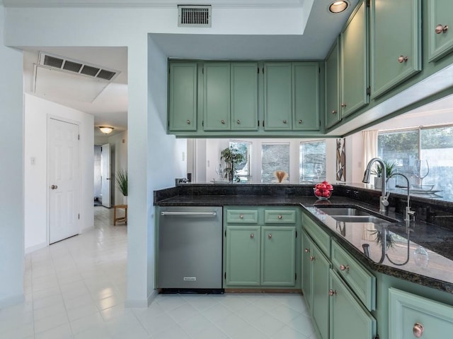 kitchen featuring green cabinetry, visible vents, dark stone countertops, and a sink