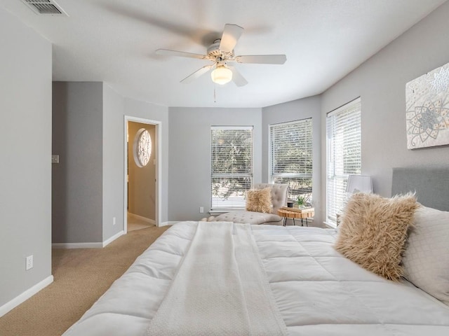 carpeted bedroom featuring visible vents, ceiling fan, and baseboards