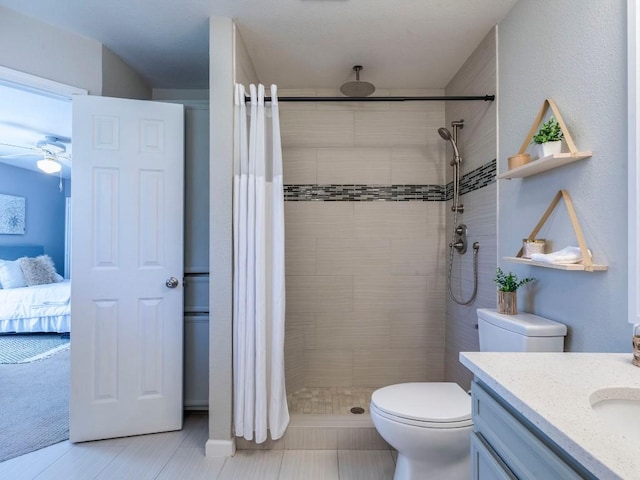 full bath featuring tiled shower, toilet, ensuite bathroom, and vanity