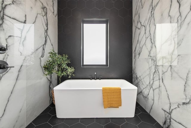 bathroom featuring tile patterned floors and a freestanding tub