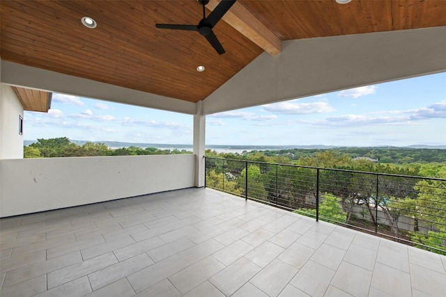 view of patio / terrace with a balcony, a wooded view, and ceiling fan