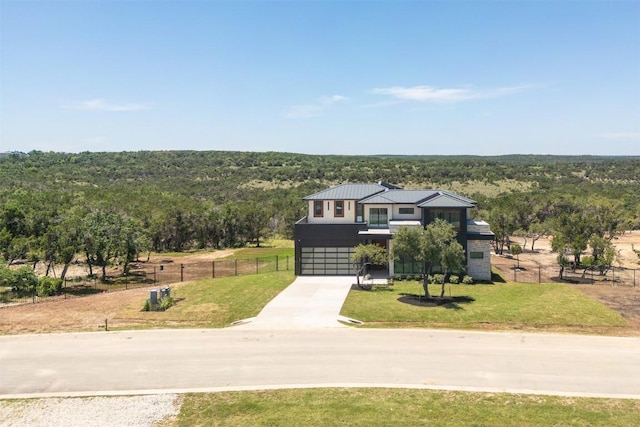 8112 Kuhn Dr, Austin, TX 78736 - view of front facade with driveway, a forest view, a garage, a standing seam roof, and a metal roof