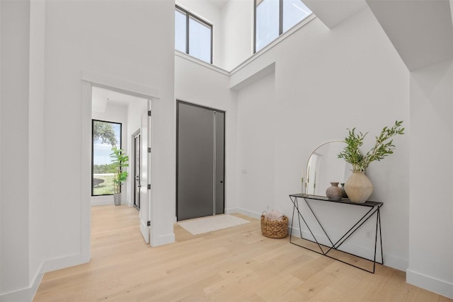 8112 Kuhn Dr, Austin, TX 78736 - entrance foyer featuring light wood-style floors, a high ceiling, and baseboards